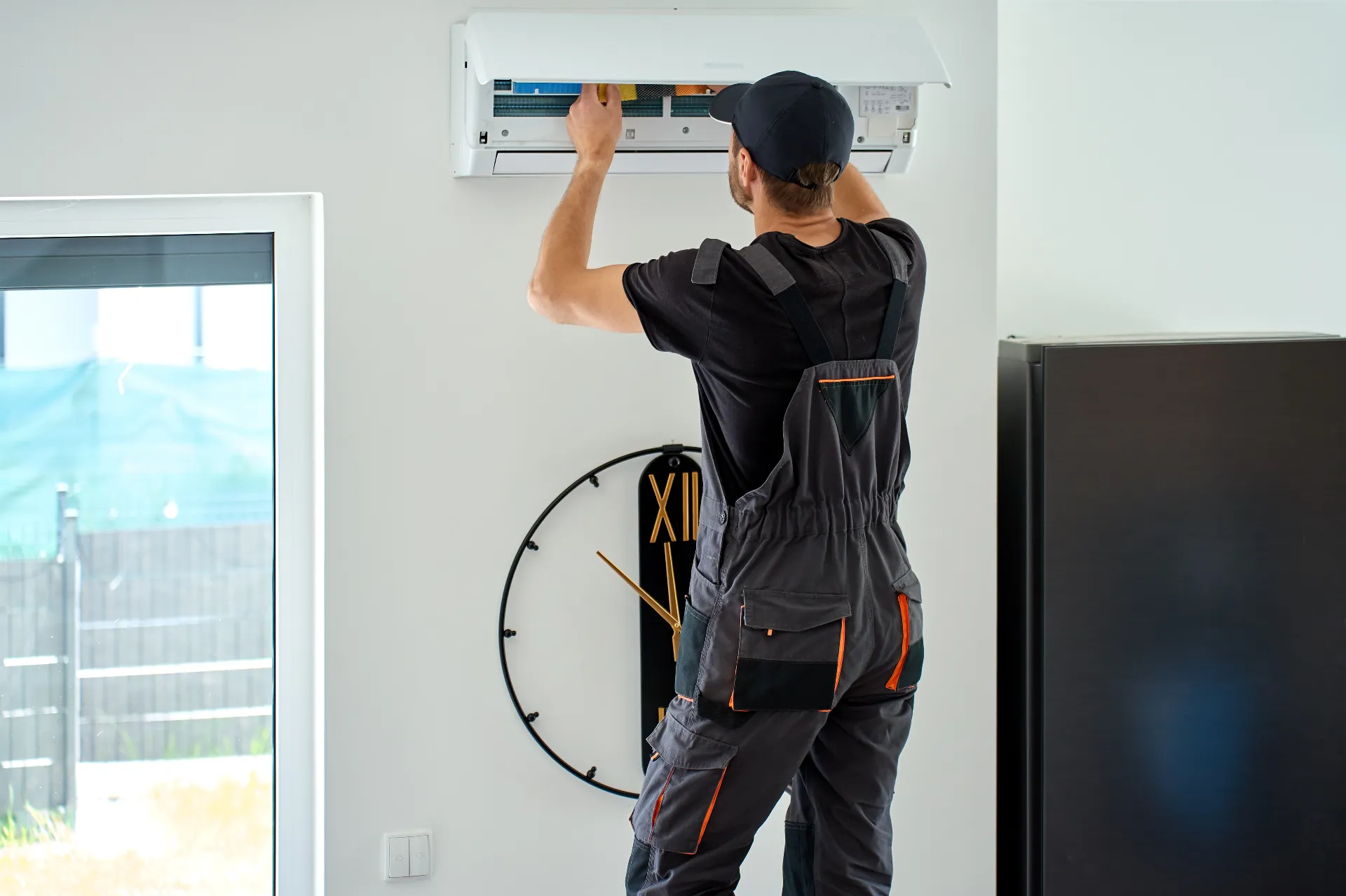 HVAC technician checking air conditioner indoor unit