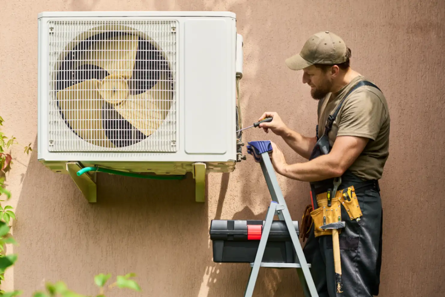 HVAC technician installing new air conditioning unit residential home